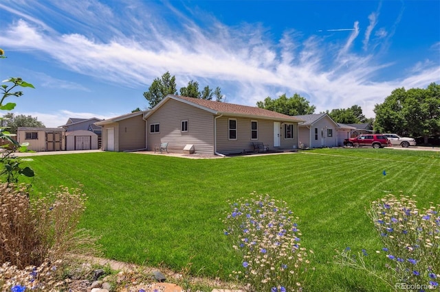 1418 5th St, Fort Lupton, CO 80621 - view of front facade featuring a storage unit, an attached garage, a front lawn, and a patio