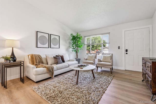 1418 5th St, Fort Lupton, CO 80621 - living area with light wood finished floors and a textured ceiling