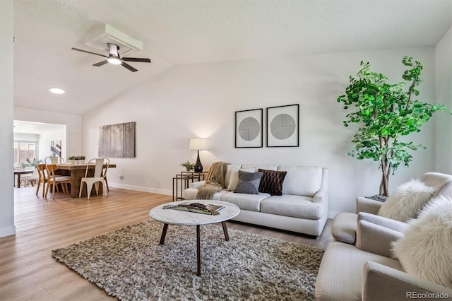 1418 5th St, Fort Lupton, CO 80621 - living area featuring light wood-style floors, vaulted ceiling, and a ceiling fan