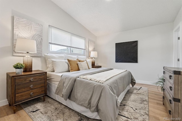 1418 5th St, Fort Lupton, CO 80621 - bedroom featuring lofted ceiling, light wood-type flooring, and a textured ceiling