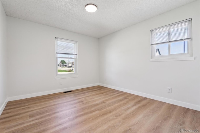 1418 5th St, Fort Lupton, CO 80621 - spare room featuring a textured ceiling and light wood finished floors