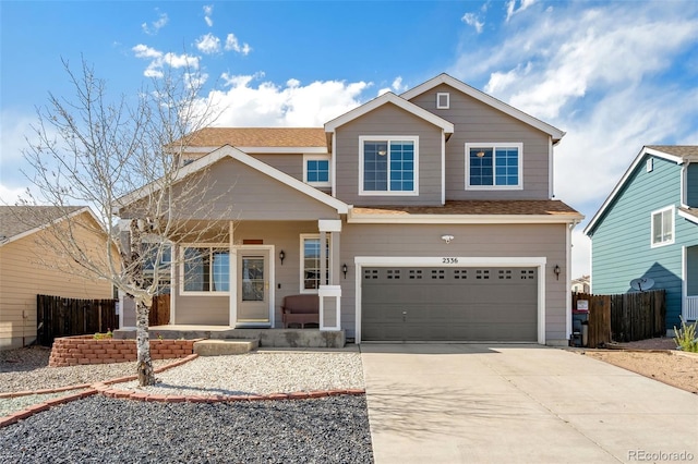 2336 Klein Pl, Colorado Springs, CO 80951 - view of front facade featuring an attached garage, fence, a porch, and driveway