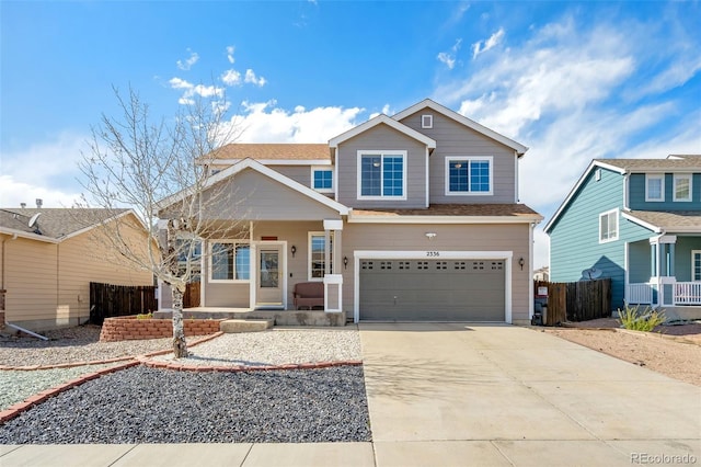 2336 Klein Pl, Colorado Springs, CO 80951 - view of front facade with a porch, an attached garage, driveway, and fence