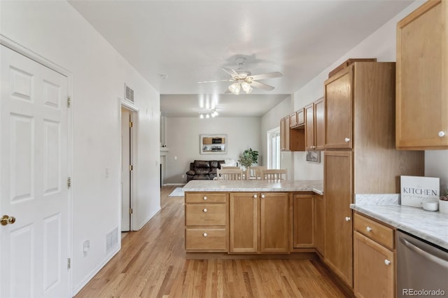 2336 Klein Pl, Colorado Springs, CO 80951 - kitchen featuring a peninsula, stainless steel dishwasher, visible vents, and light wood-type flooring