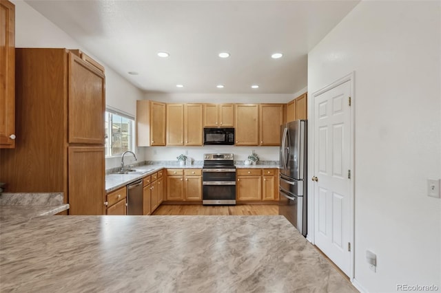 2336 Klein Pl, Colorado Springs, CO 80951 - kitchen with light wood finished floors, a sink, recessed lighting, light countertops, and appliances with stainless steel finishes