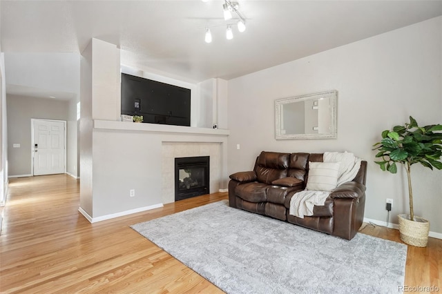 2336 Klein Pl, Colorado Springs, CO 80951 - living room featuring a fireplace, wood finished floors, and baseboards