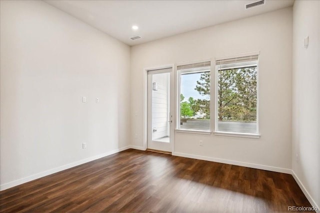 spare room featuring dark hardwood / wood-style flooring