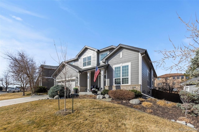 craftsman inspired home with brick siding, driveway, and a front yard