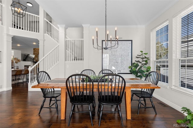 dining area featuring dark wood finished floors, crown molding, stairway, and a chandelier