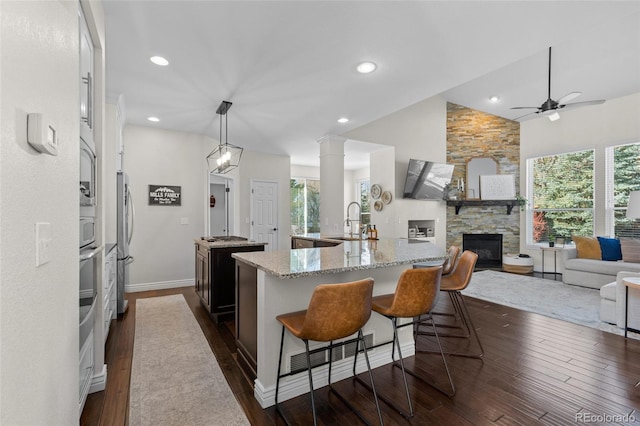 kitchen featuring a sink, a wealth of natural light, a spacious island, and ceiling fan