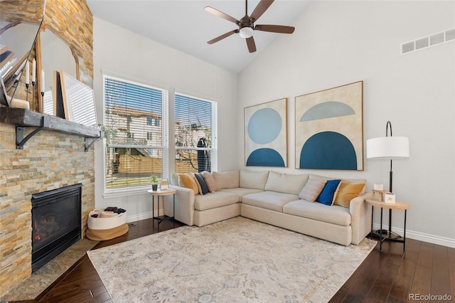 living room with visible vents, baseboards, a ceiling fan, and dark wood-style flooring