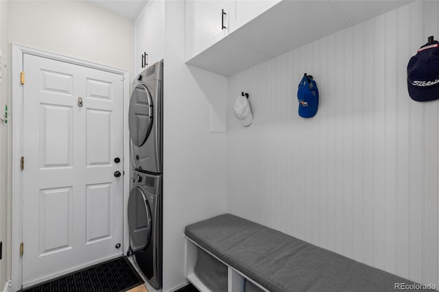 interior space featuring stacked washer / dryer and cabinet space