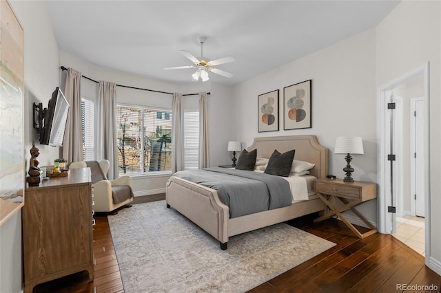 bedroom with dark wood-type flooring, baseboards, and ceiling fan