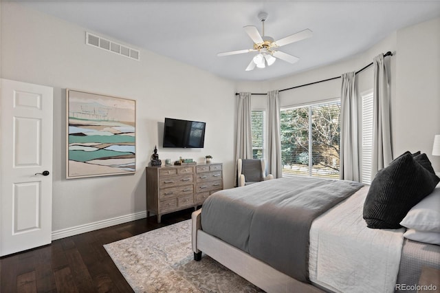 bedroom featuring visible vents, baseboards, ceiling fan, and dark wood-style flooring