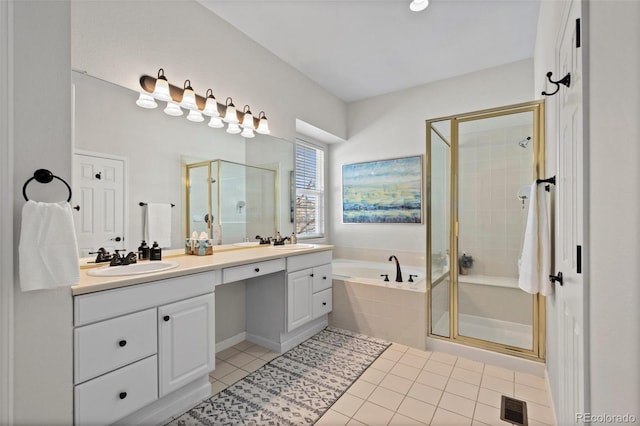 bathroom with visible vents, a stall shower, a garden tub, and a sink