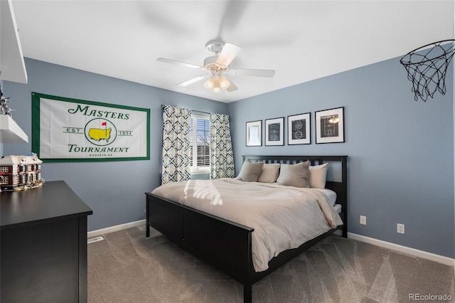 carpeted bedroom with ceiling fan and baseboards