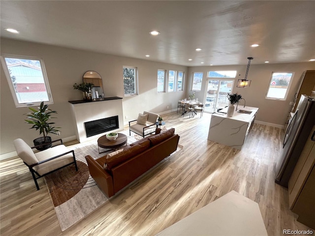 living room with sink and light hardwood / wood-style floors