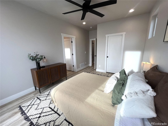 bedroom with light hardwood / wood-style floors and ceiling fan