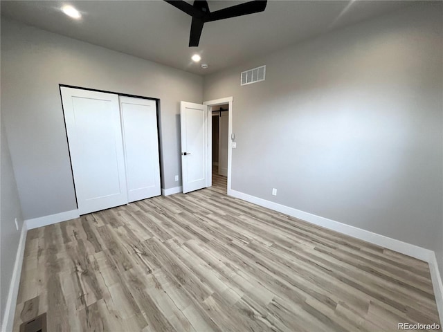 unfurnished bedroom featuring a closet, ceiling fan, and light hardwood / wood-style floors