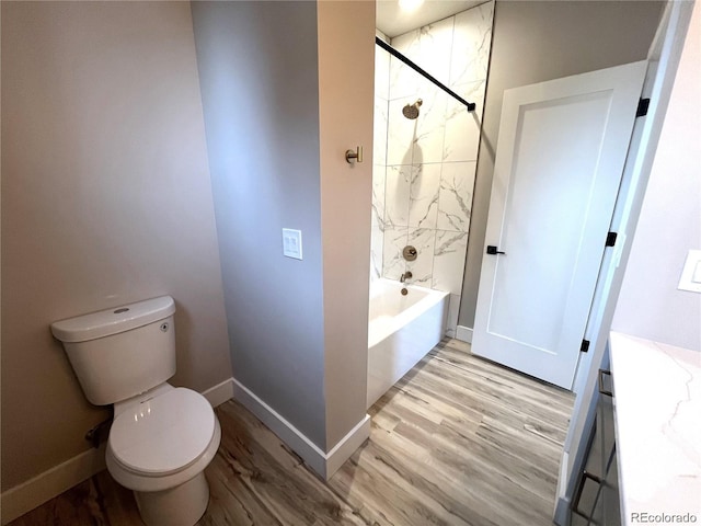 full bathroom with shower / tub combination, vanity, wood-type flooring, and toilet