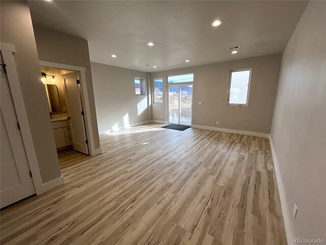 empty room with light hardwood / wood-style flooring