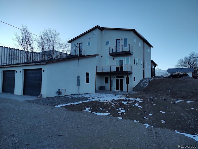 exterior space featuring a garage and a balcony