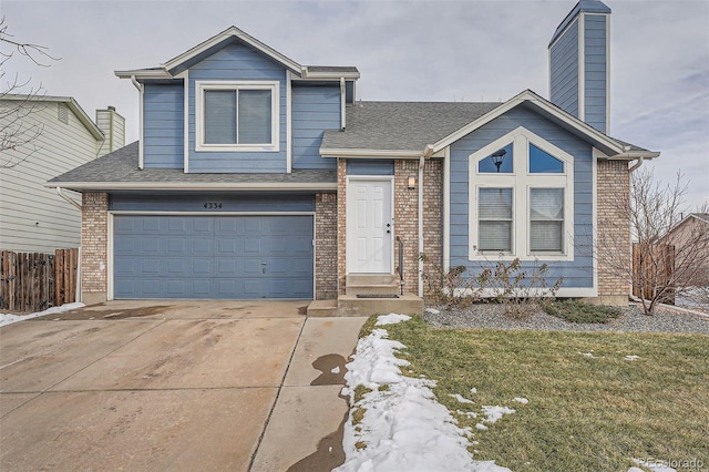 view of front of house featuring a garage and a front lawn