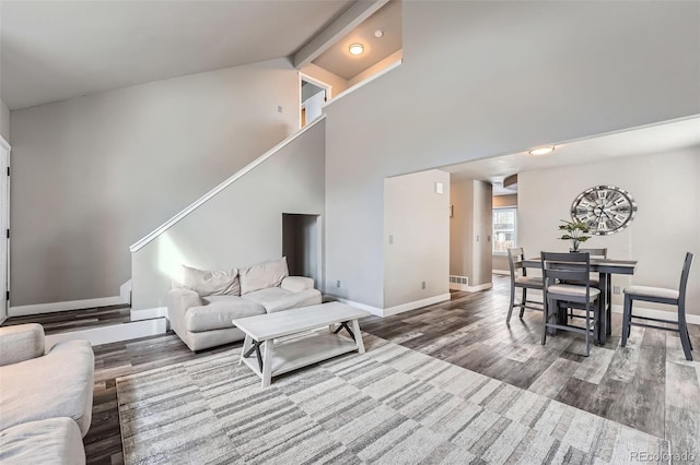 living room featuring hardwood / wood-style floors and high vaulted ceiling