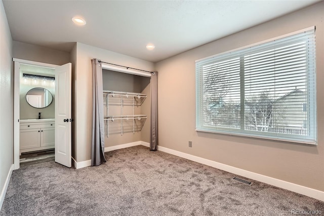 unfurnished bedroom with carpet floors and sink