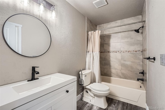 full bathroom with shower / bathtub combination with curtain, a textured ceiling, toilet, vanity, and hardwood / wood-style flooring