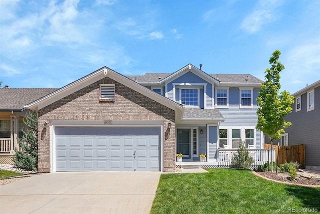 19075 E Grand Cir, Aurora, CO 80015 - view of front of house with driveway, brick siding, a garage, and a shingled roof