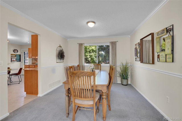 19075 E Grand Cir, Aurora, CO 80015 - dining space with a textured ceiling, ornamental molding, light colored carpet, and baseboards