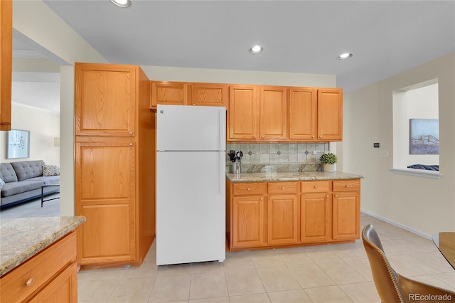 19075 E Grand Cir, Aurora, CO 80015 - kitchen with freestanding refrigerator, backsplash, light tile patterned flooring, recessed lighting, and light stone countertops
