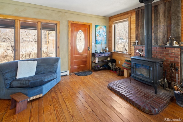 400 W Galena, Moffat, CO 81131 - entryway with a wood stove, baseboard heating, and hardwood / wood-style flooring
