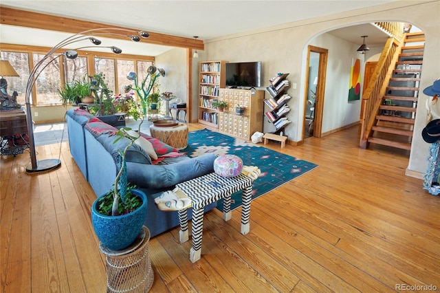 400 W Galena, Moffat, CO 81131 - living room featuring stairs, arched walkways, wood-type flooring, and beam ceiling