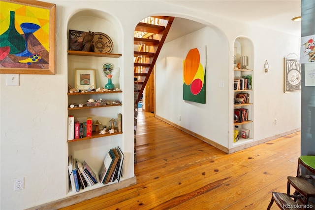 400 W Galena, Moffat, CO 81131 - corridor featuring wood-type flooring, stairway, built in shelves, and arched walkways