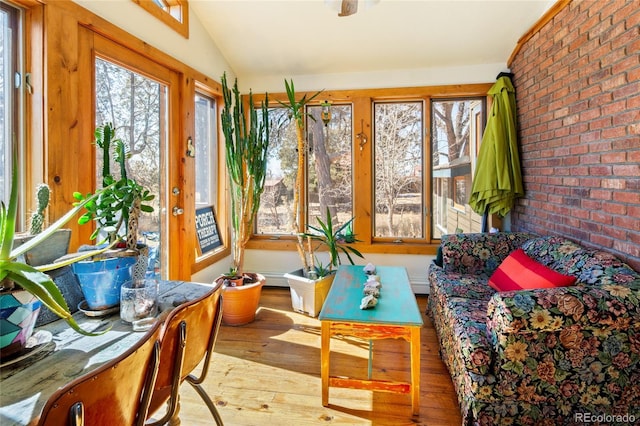 400 W Galena, Moffat, CO 81131 - sunroom / solarium with hardwood / wood-style flooring, lofted ceiling, and brick wall