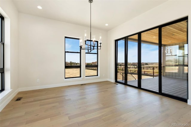 1889 Spring Bloom Dr, Windsor, CO 80550 - empty room with a chandelier, light wood finished floors, baseboards, and recessed lighting