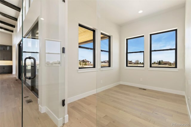 1889 Spring Bloom Dr, Windsor, CO 80550 - unfurnished bedroom with multiple windows, light wood-style flooring, baseboards, and recessed lighting