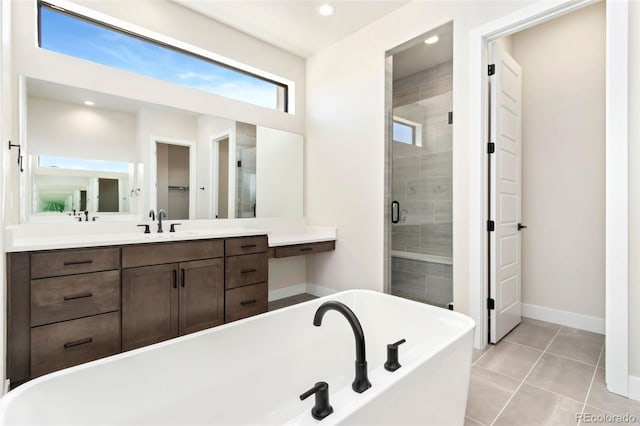 1889 Spring Bloom Dr, Windsor, CO 80550 - full bathroom with a soaking tub, vanity, a shower stall, baseboards, and tile patterned flooring