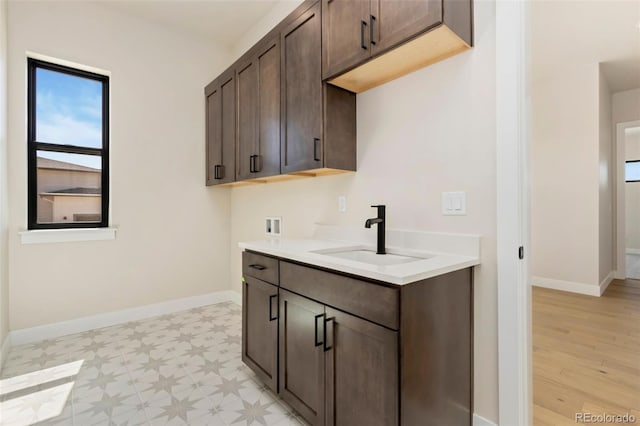 1889 Spring Bloom Dr, Windsor, CO 80550 - laundry room with hookup for a washing machine, cabinet space, light floors, and baseboards
