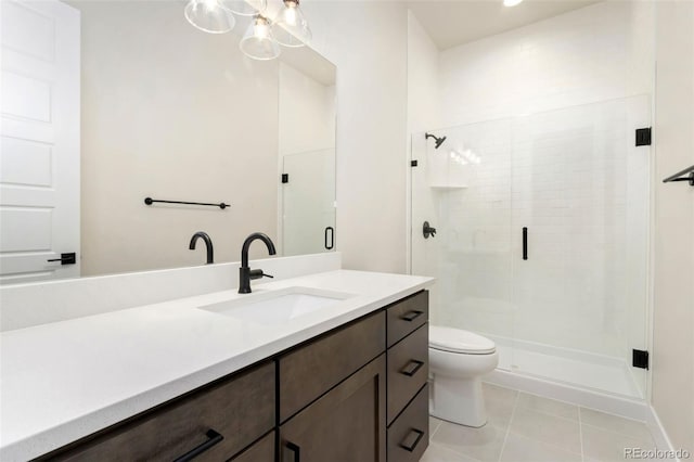 1889 Spring Bloom Dr, Windsor, CO 80550 - bathroom featuring vanity, a shower stall, toilet, and tile patterned floors