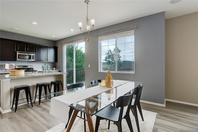 5546 Echo Hollow St, Castle Rock, CO 80104 - dining room with light wood-style flooring, baseboards, recessed lighting, and a chandelier