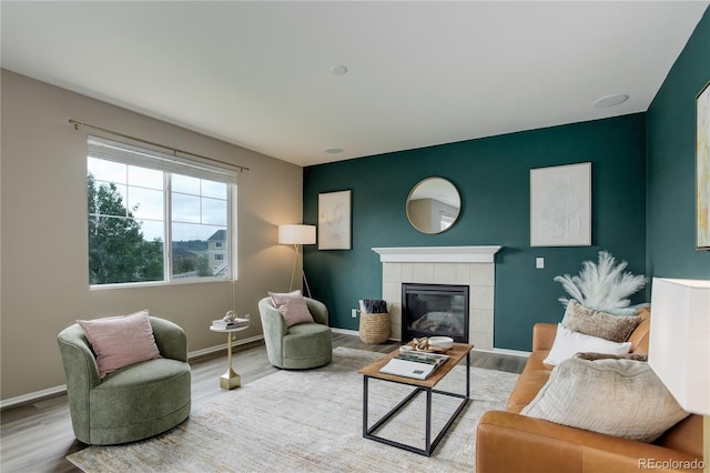 5546 Echo Hollow St, Castle Rock, CO 80104 - living area with wood finished floors, a tile fireplace, and baseboards