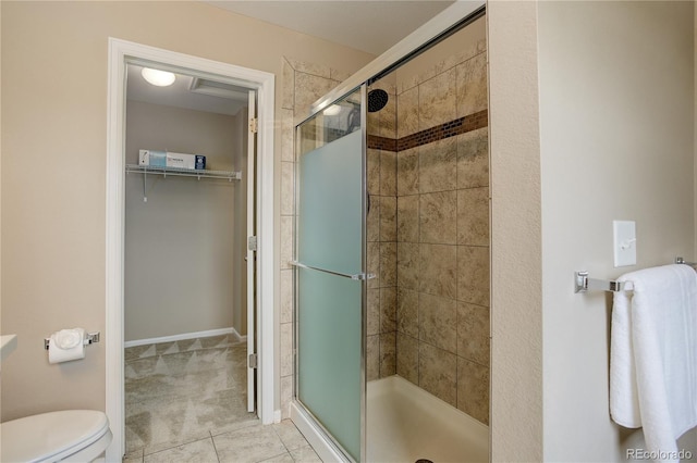 5546 Echo Hollow St, Castle Rock, CO 80104 - full bath featuring a stall shower, a spacious closet, toilet, and tile patterned floors