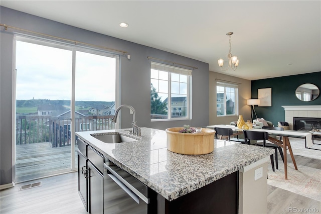 5546 Echo Hollow St, Castle Rock, CO 80104 - kitchen featuring stainless steel dishwasher, a sink, light wood finished floors, open floor plan, and recessed lighting