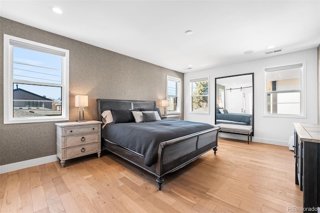 bedroom with light wood finished floors, baseboards, visible vents, and recessed lighting