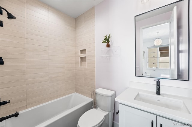 bathroom with washtub / shower combination, vanity, and toilet