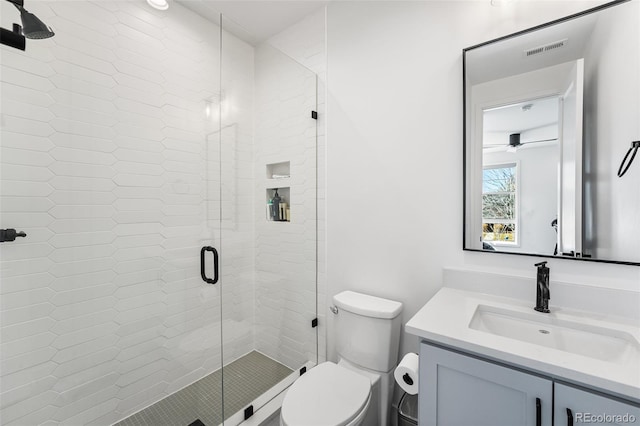 full bath featuring toilet, a stall shower, visible vents, and vanity