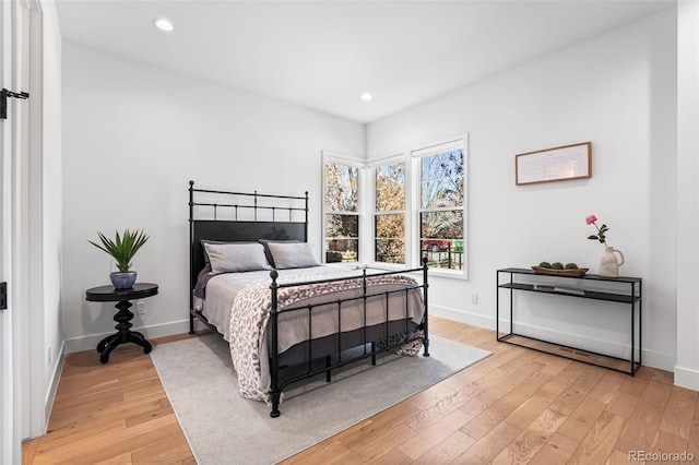 bedroom with baseboards, light wood-style flooring, and recessed lighting